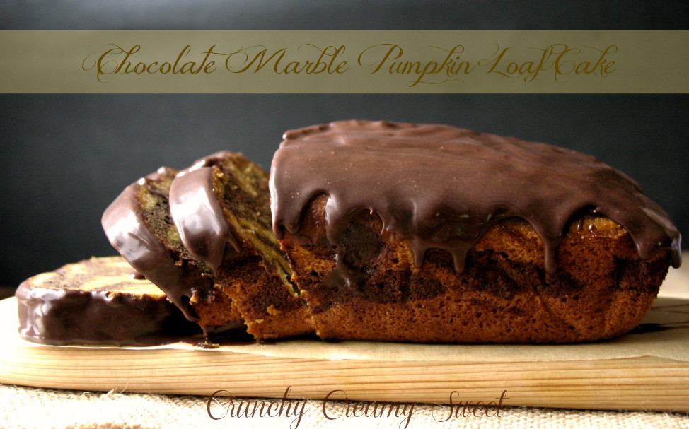Pumpkin loaf cake with chocolate glaze on cutting board.