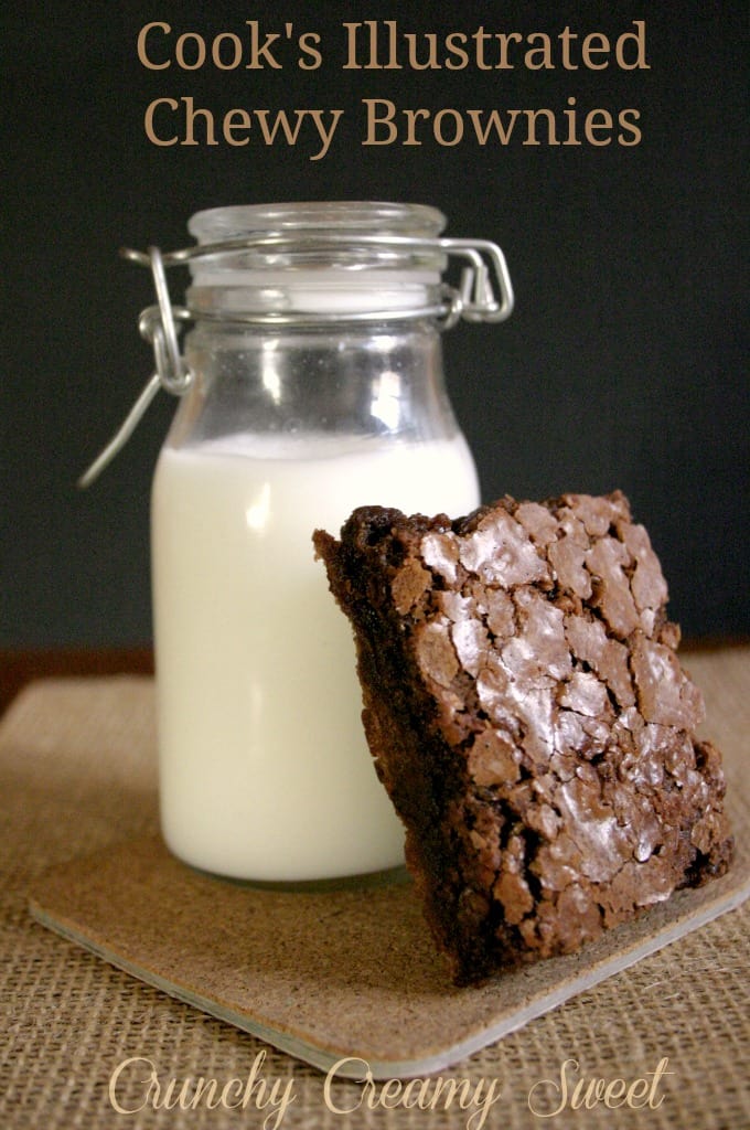 Small bottle with milk with one brownie leaning on it.