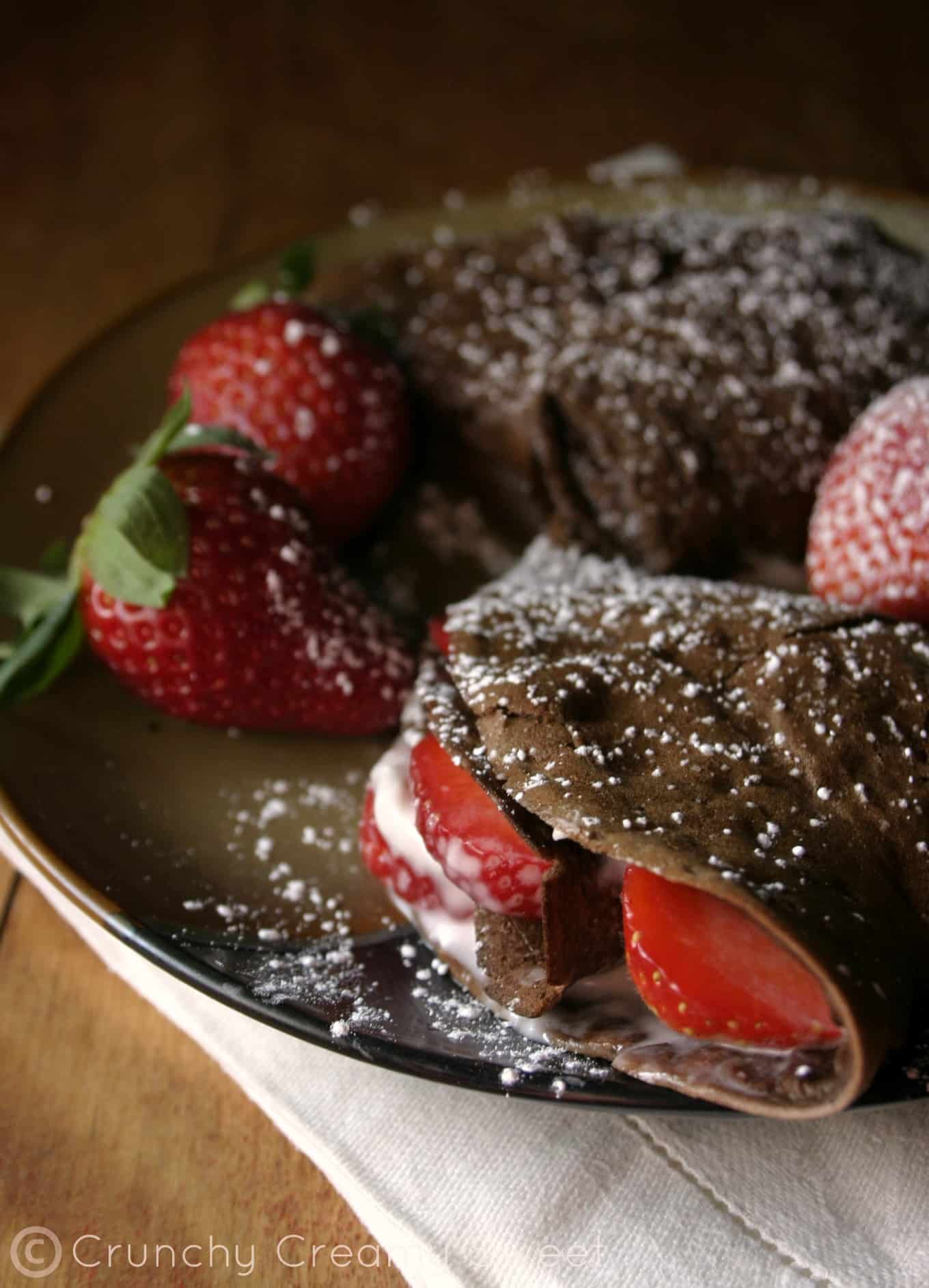 Chocolate Crepes with Strawberries and Cream Cheese - elegant breakfast or brunch idea that's quite easy to make. Delicious chocolate crepes filled with cream cheese and strawberries.