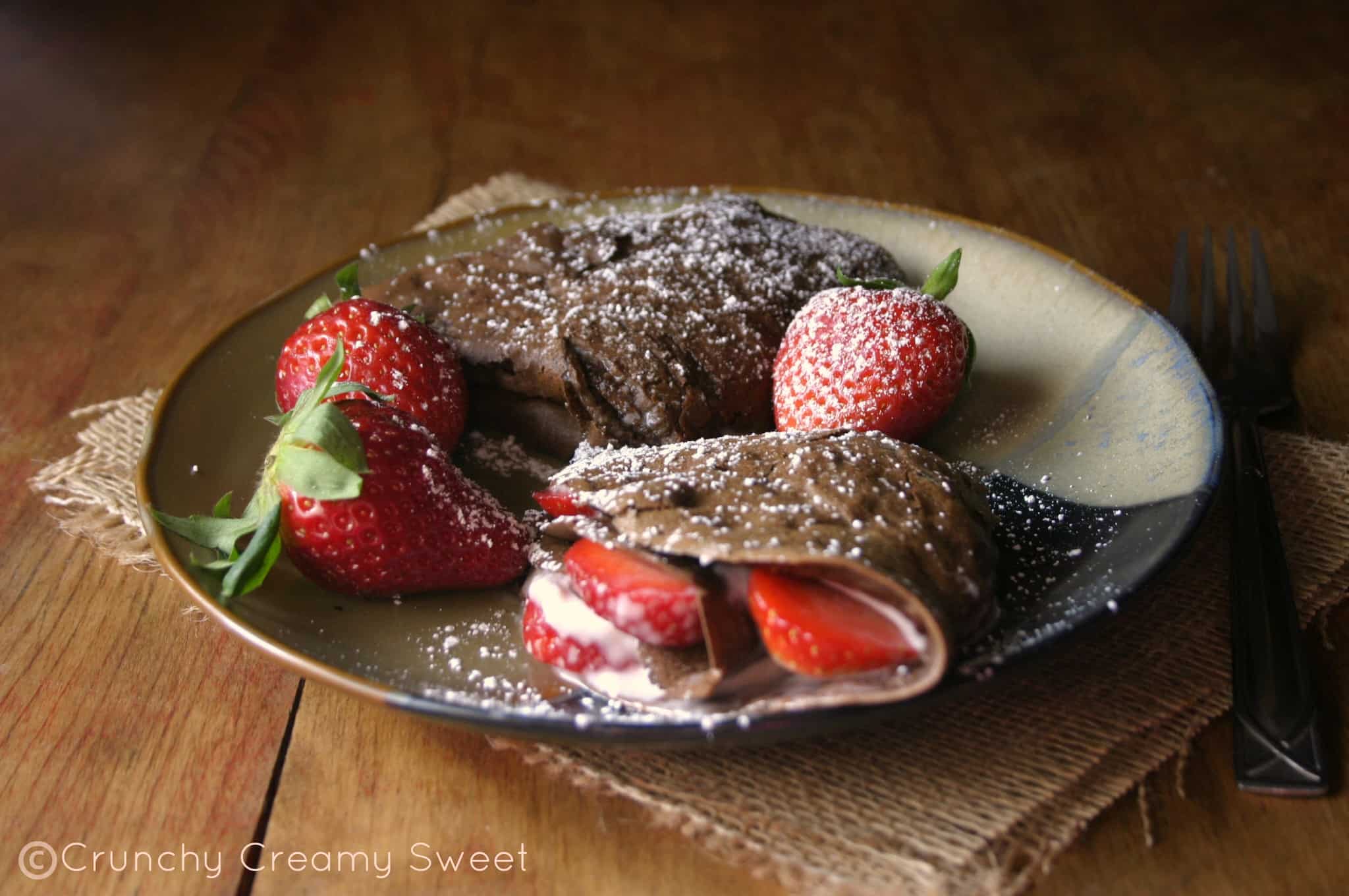Chocolate Crepes with Strawberries and Cream Cheese - elegant breakfast or brunch idea that's quite easy to make. Delicious chocolate crepes filled with cream cheese and strawberries.