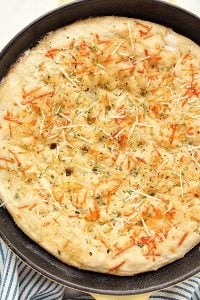 Skillet Focaccia with Parmesan cheese on top.