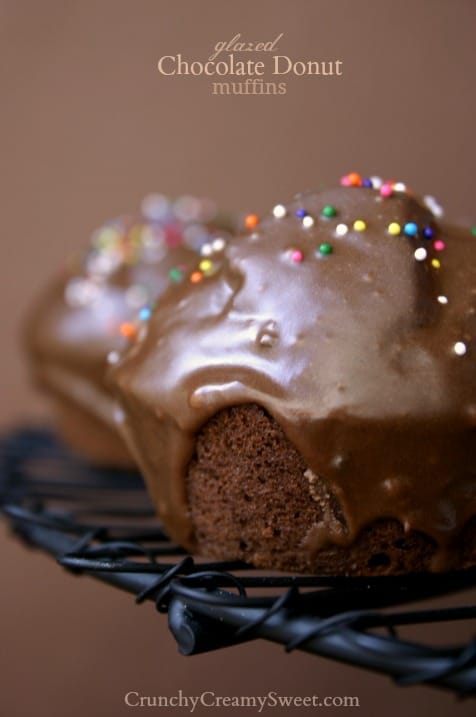 Glazed Chocolate Donut Muffins - perfect treat when you want a donut and a muffin in the same time! The chocolate glaze is crazy good! Side close up shot of chocolate glazed donut muffin on cooling rack.