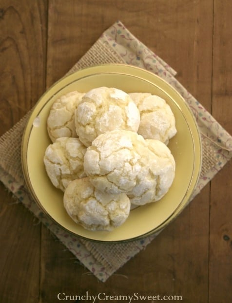 Overhead shot of yellow plate with lemon cookies on wooden background.