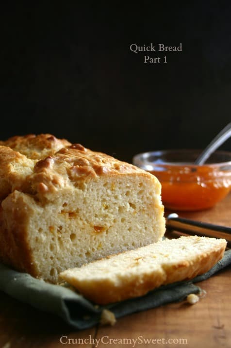 Side shot of sliced quick bread with apricot preserves. 