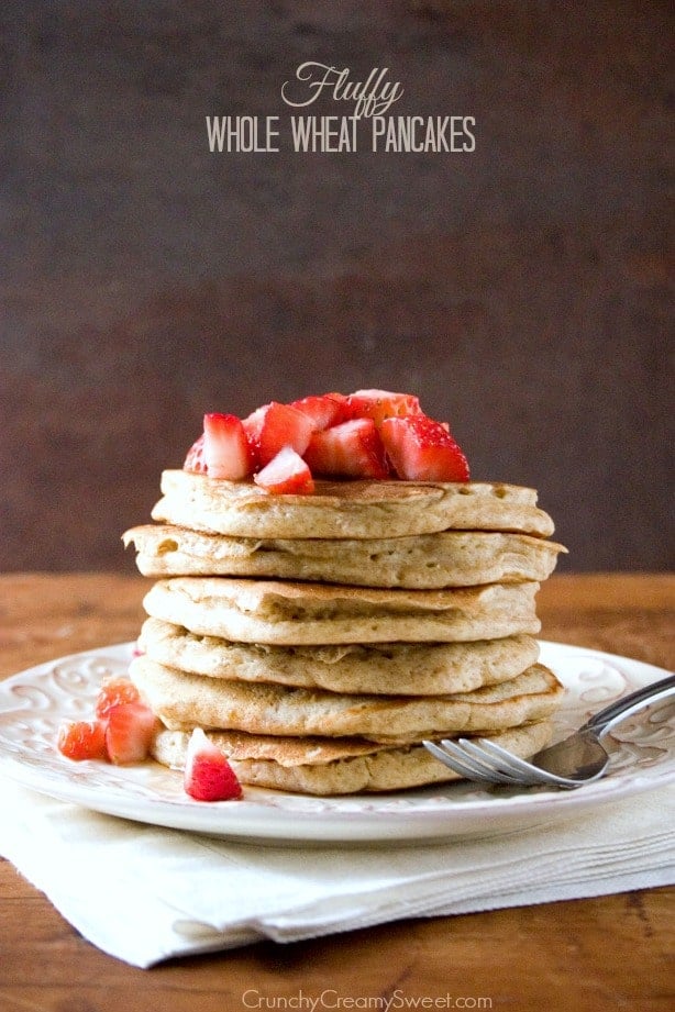 Side shot of a stack of whole wheat pancakes on plate.