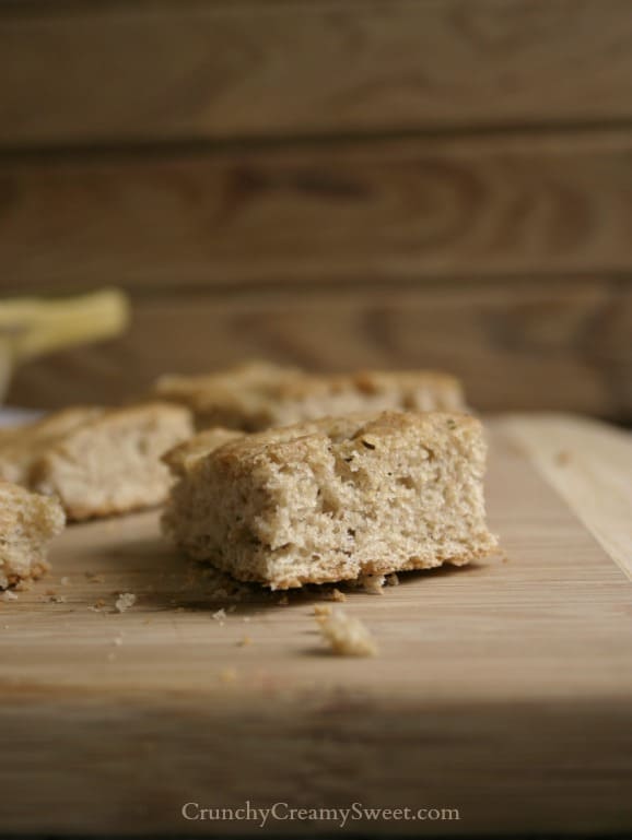 Piece of whole wheat focaccia on cutting board.