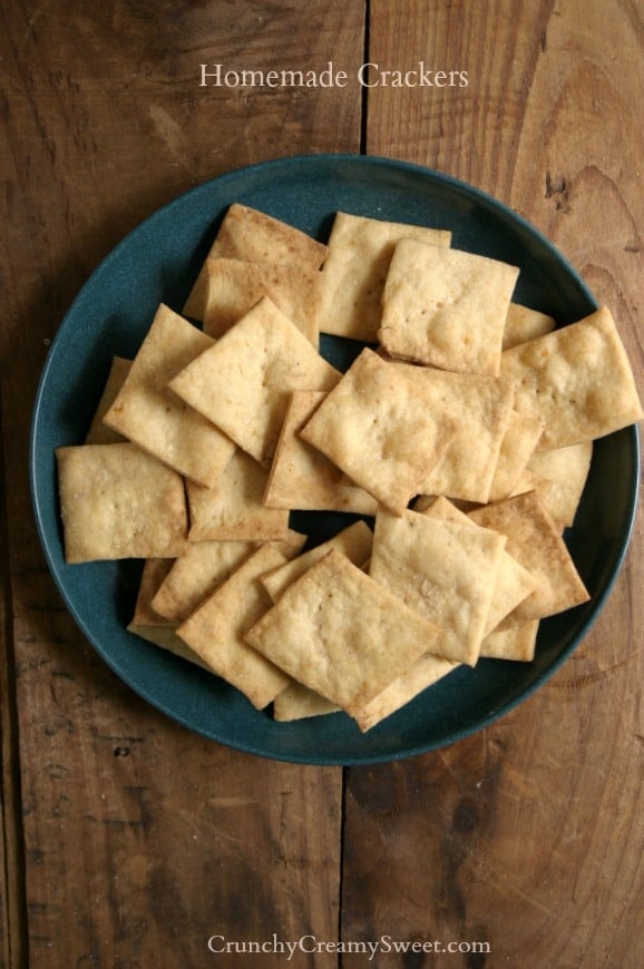 You can make Homemade Crackers in under 20 minutes. Super easy and way better than store-bought kind! Overhead shot of homemade crackers on blue plate.