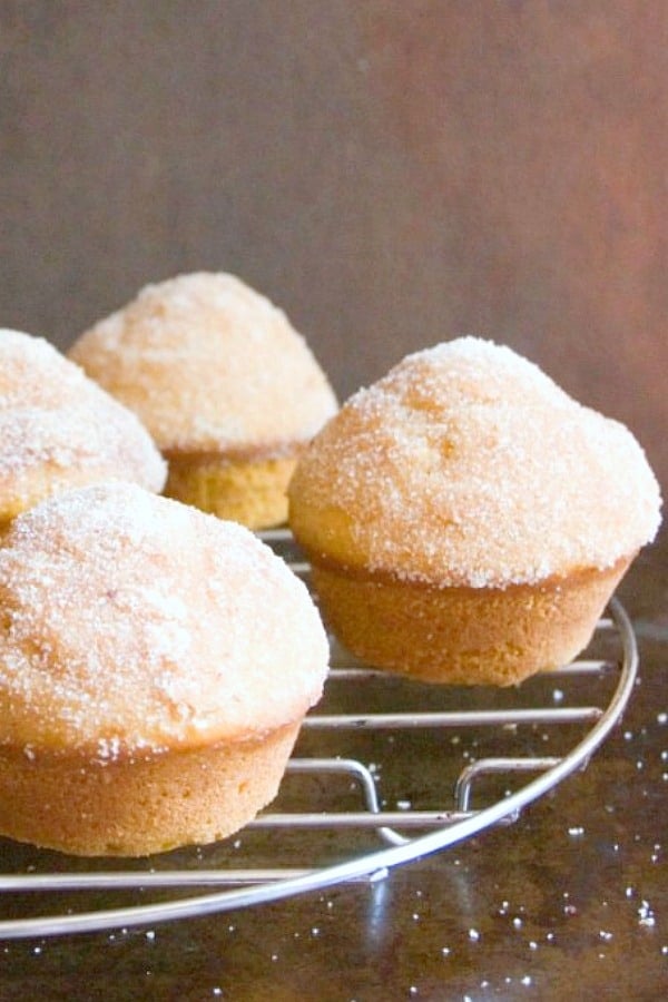 Cinnamon Sugar Coated Pumpkin Donut Muffins on a cooling rack.