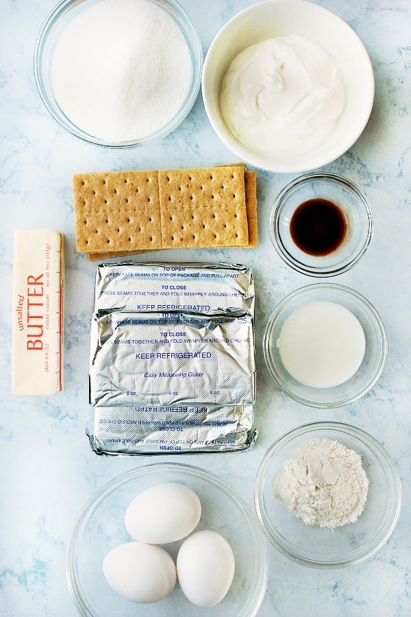 Perfect cheesecake ingredients on a marble board.