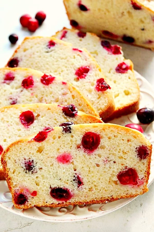 Cranberry Bread sliced on a white plate.