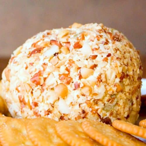 Bacon and Olive Cheese Ball on a plate with crackers.