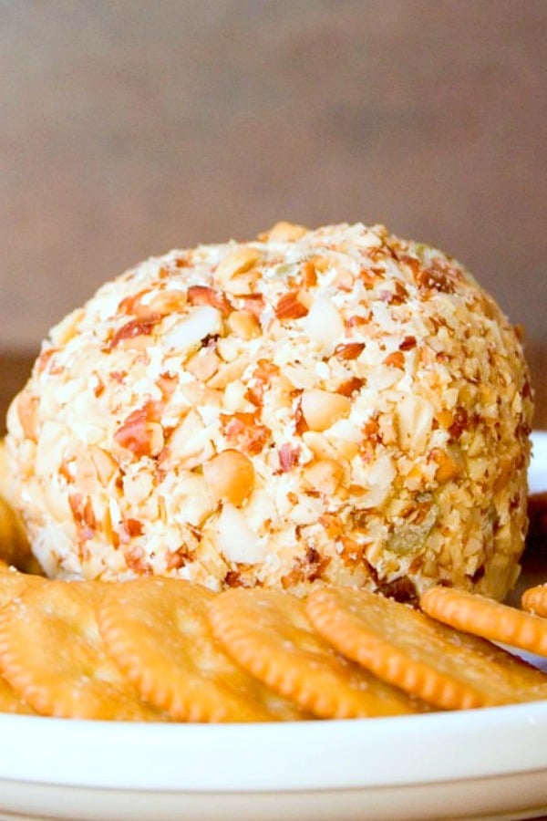 Bacon and Olive Cheese Ball on a plate with crackers.