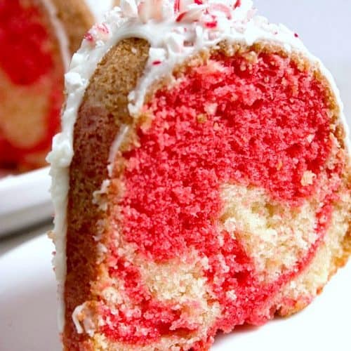 Slice of Peppermint Candy can bundt cake on a plate.