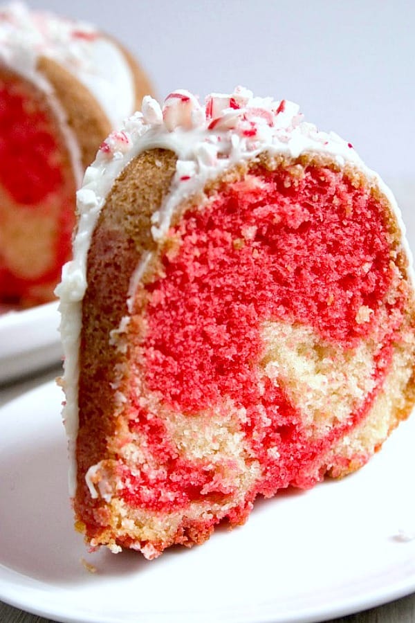 Slice of Peppermint Candy can bundt cake on a plate.