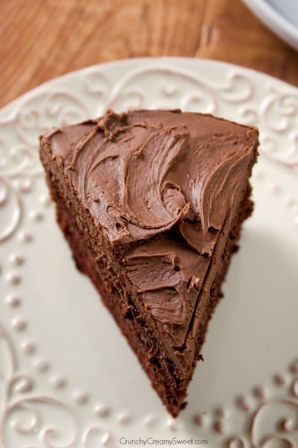 Overhead shot of one slice of chocolate cake with frosting.