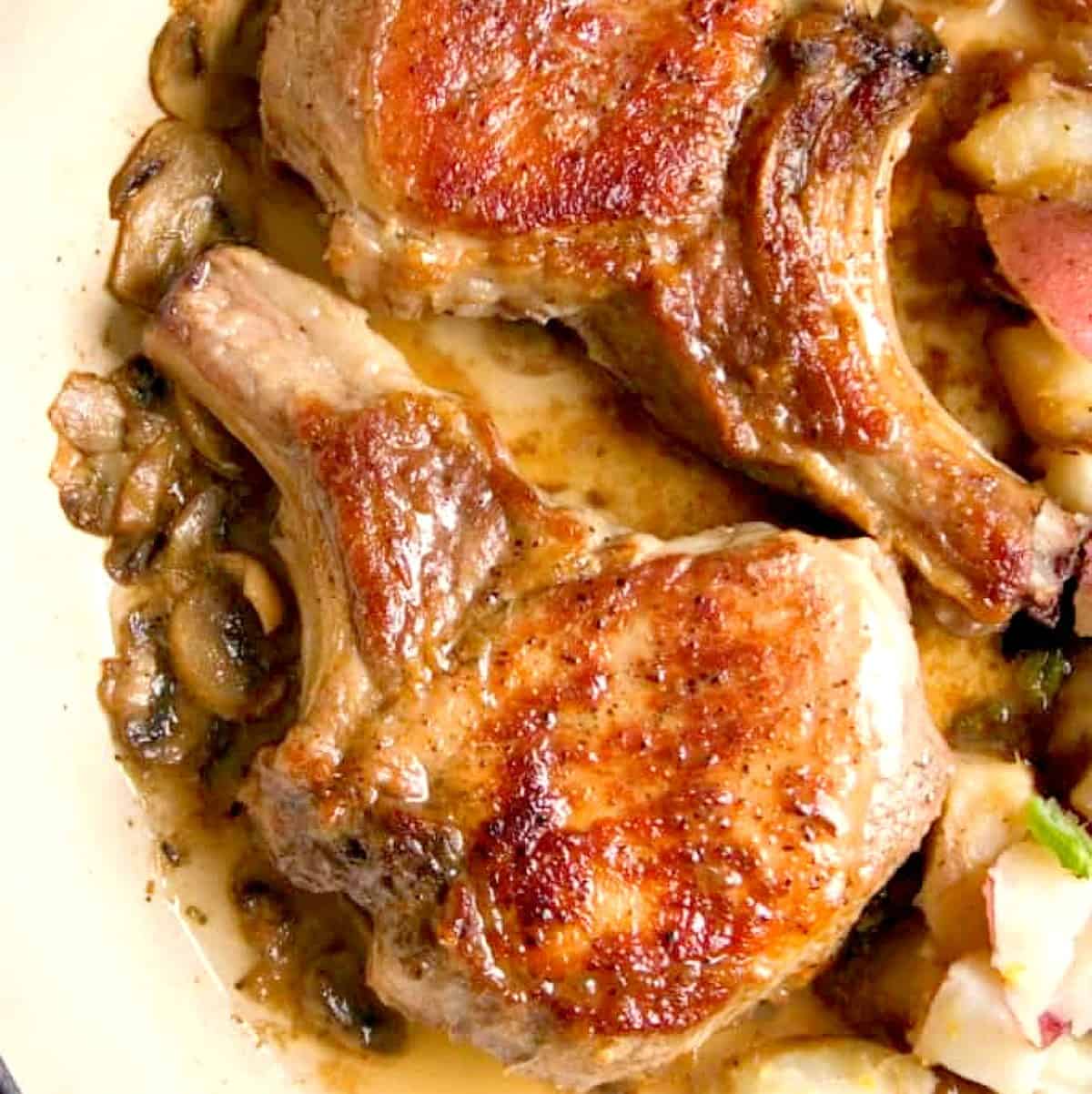 Pork chops in a pan.
