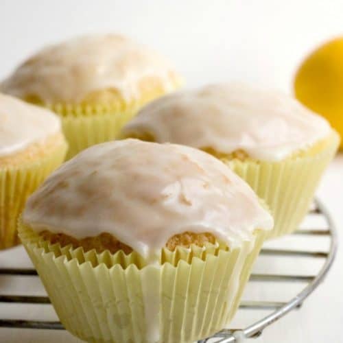 Glazed Lemon Muffins on a rack.