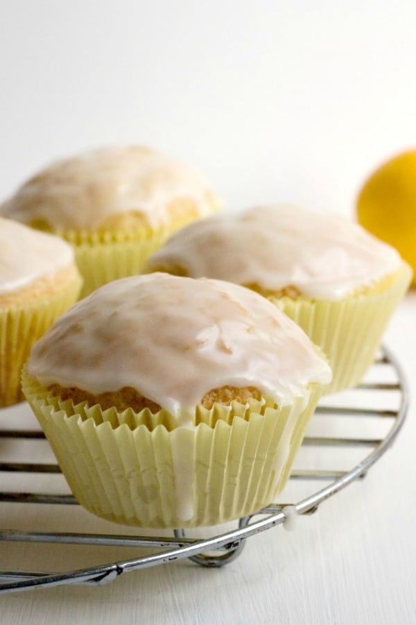 Glazed Lemon Muffins on a rack.