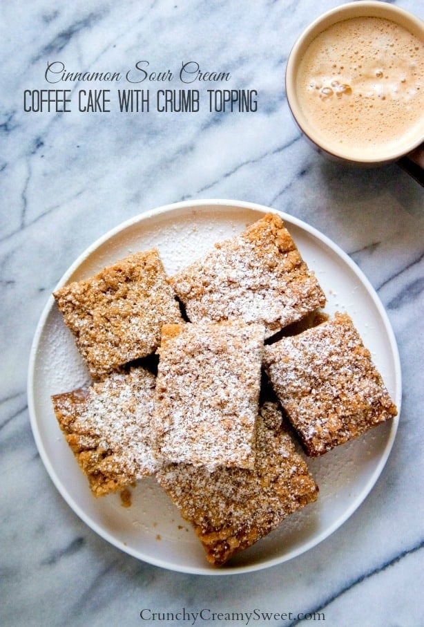 Overhead shot of crumb coffee cake on plate with coffee in cup next to it.