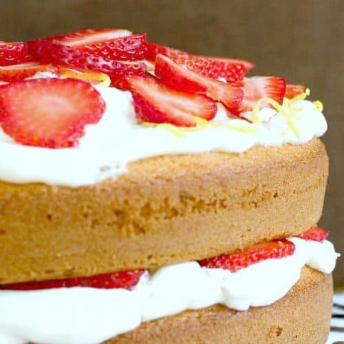 Lemon and Strawberry Layer Cake on a cooling rack.