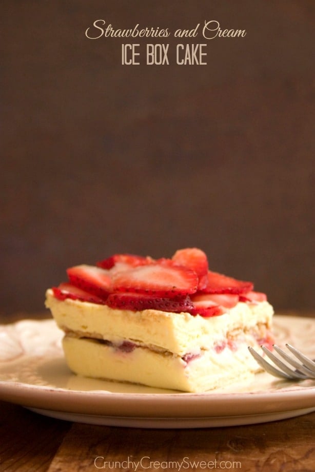 Side shot of one square on strawberry ice box cake on plate with fork.