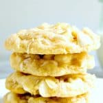 White Chocolate Coconut cookies stacked on plate.