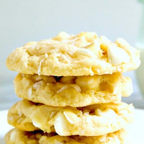 White Chocolate Coconut cookies stacked on plate.