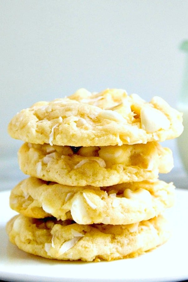 White Chocolate Coconut cookies stacked on plate.