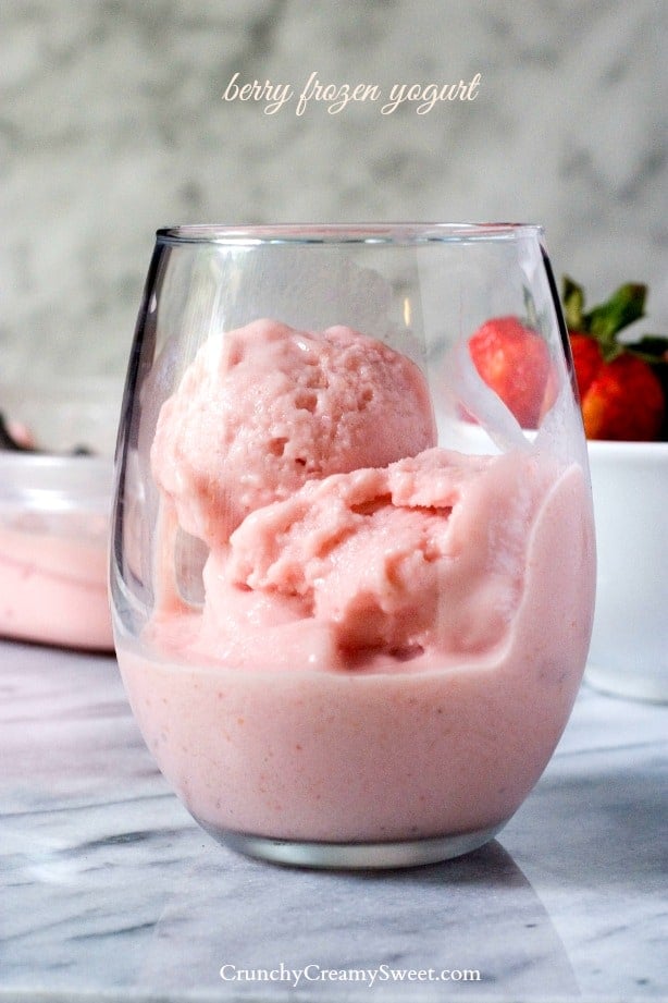 Side shot of berry frozen yogurt in a glass cup.