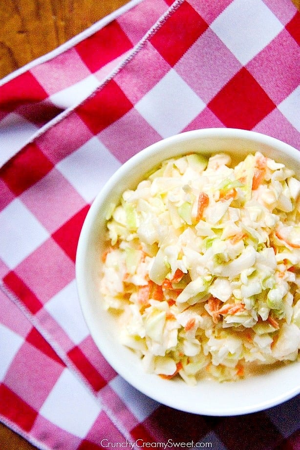 Overhead shot of coleslaw in white salad bowl.