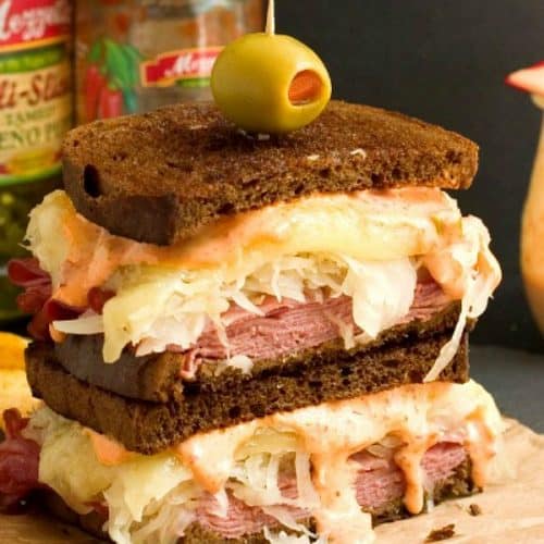 Spicy Reuben Sandwich sliced in half and stacked.