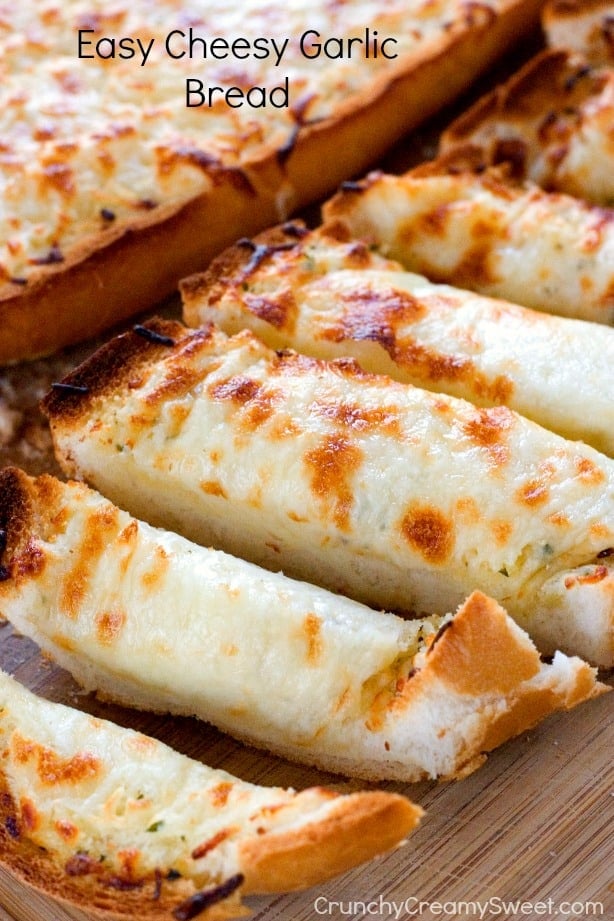 Side shot of sliced cheesy bread with the second half in the background.