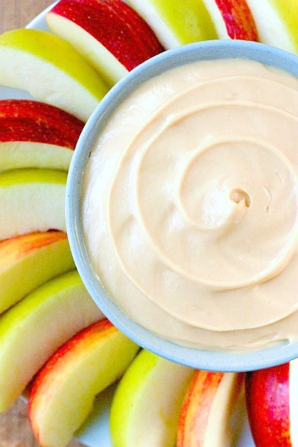 Caramel Apple Dip in a bowl surrounded by apple slices.