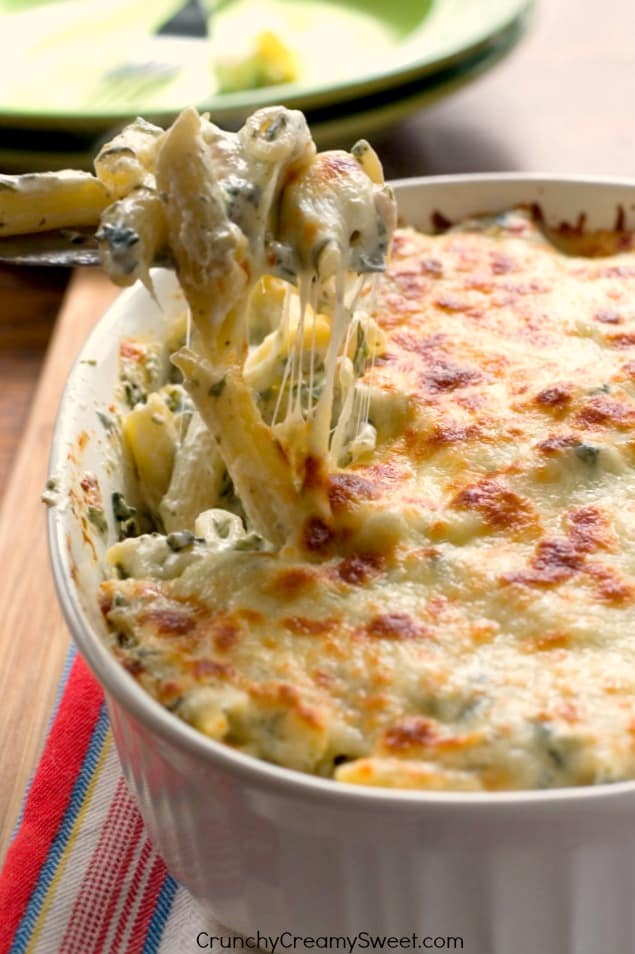 Cheesy Spinach Dip Chicken Pasta – your new favorite dinner! Spinach dip and pasta get together to create one cheesy and creamy dish! You need to make it!