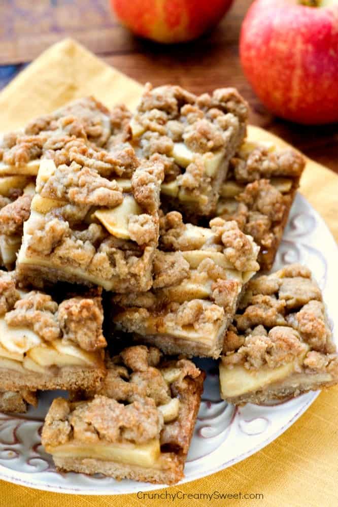 Apple Pie Bars on plate with apples next to it.