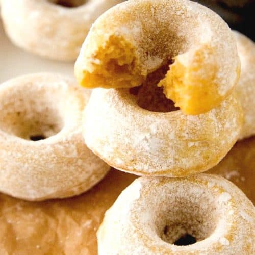 Mini Sugar Pumpkin Donuts stacked up.