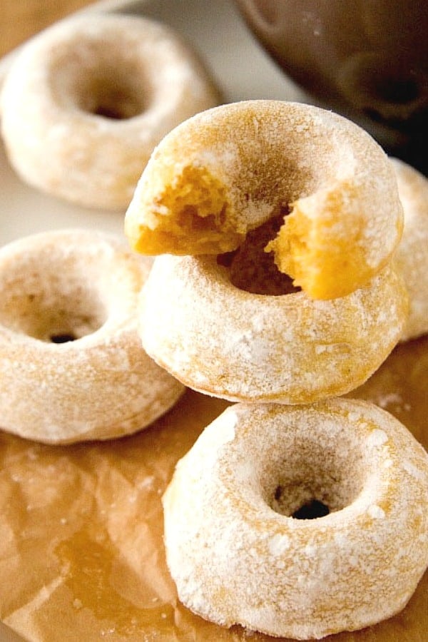 Mini Sugar Pumpkin Donuts stacked up.