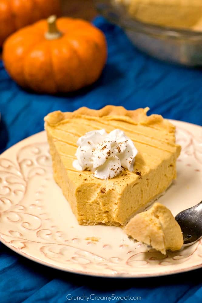 Pumpkin Mousse Pie - light and creamy pumpkin pie that's a perfect finish to a Thanksgiving dinner. Pumpkin Mousse Pie slice on a plate.