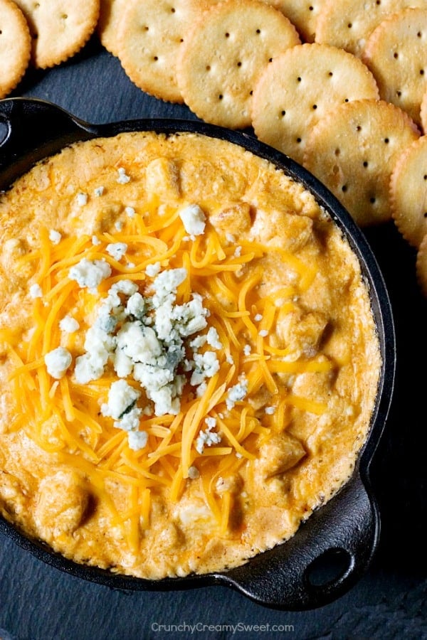 Buffalo chicken dip in black cast iron skillet.