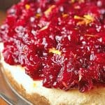 Cranberry Orange Cheesecake on a cake stand.