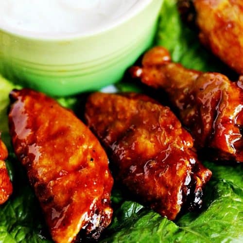 Hot wings set on lettuce leaf.