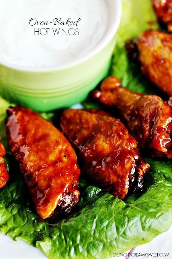 Close up shot of hot wings on lettuce leaf.