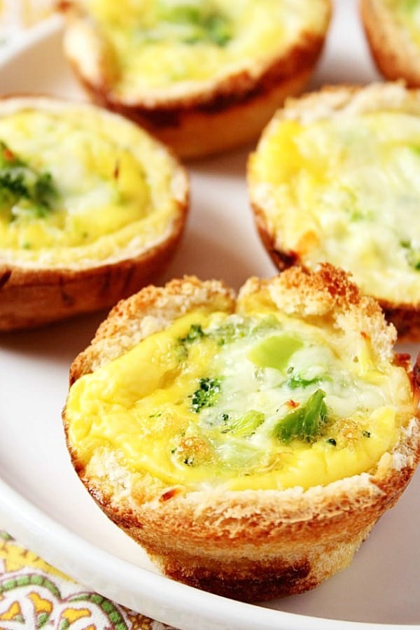 Broccoli and Cheese Mini Quiches - fresh and delicious, these mini quiches come together quickly thanks to a crust shortcut! Broccoli and Cheese Mini quiches on a plate.