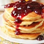 Peanut butter and jelly pancakes on a plate and napkin.