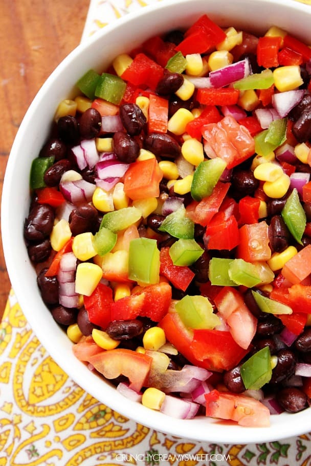 Mexican Black Bean and Corn Salad in a white bowl on napkin.