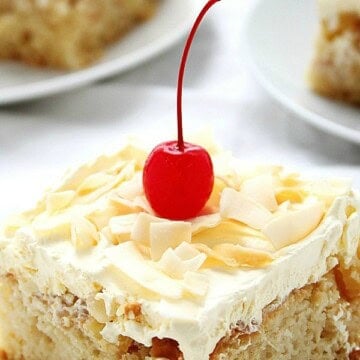 Pina Colada Poke cake slice on plate.
