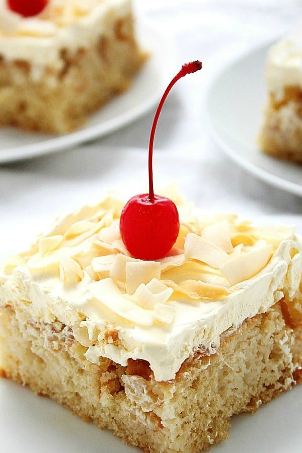 Pina Colada Poke cake slice on plate.