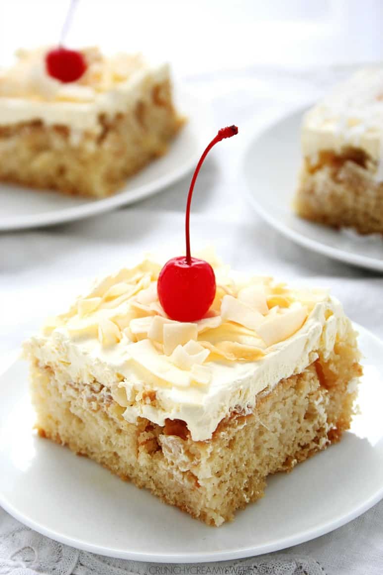 cake with coconut frosting and cherry on plate