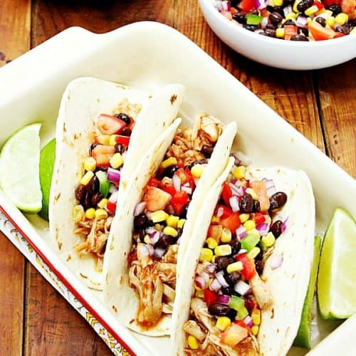 Three chicken tacos in baking dish.