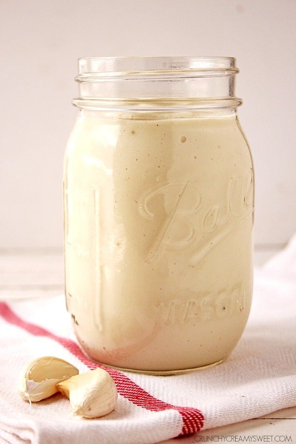 Side shot of cauliflower Alfredo sauce in a jar, without lid.